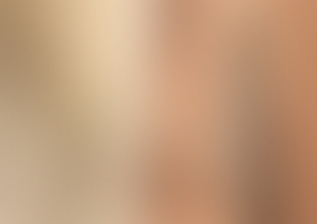 Warm neutral greige paint color swatches held against a wall