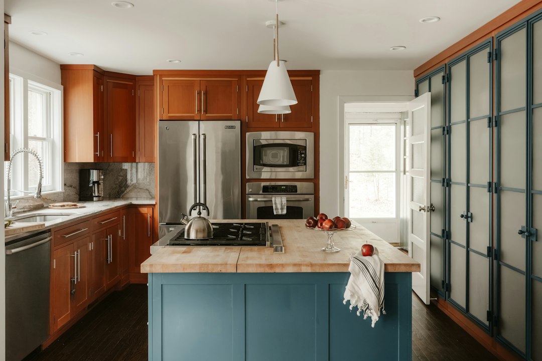 Hand wiping a stained cabinet door with a soft cloth